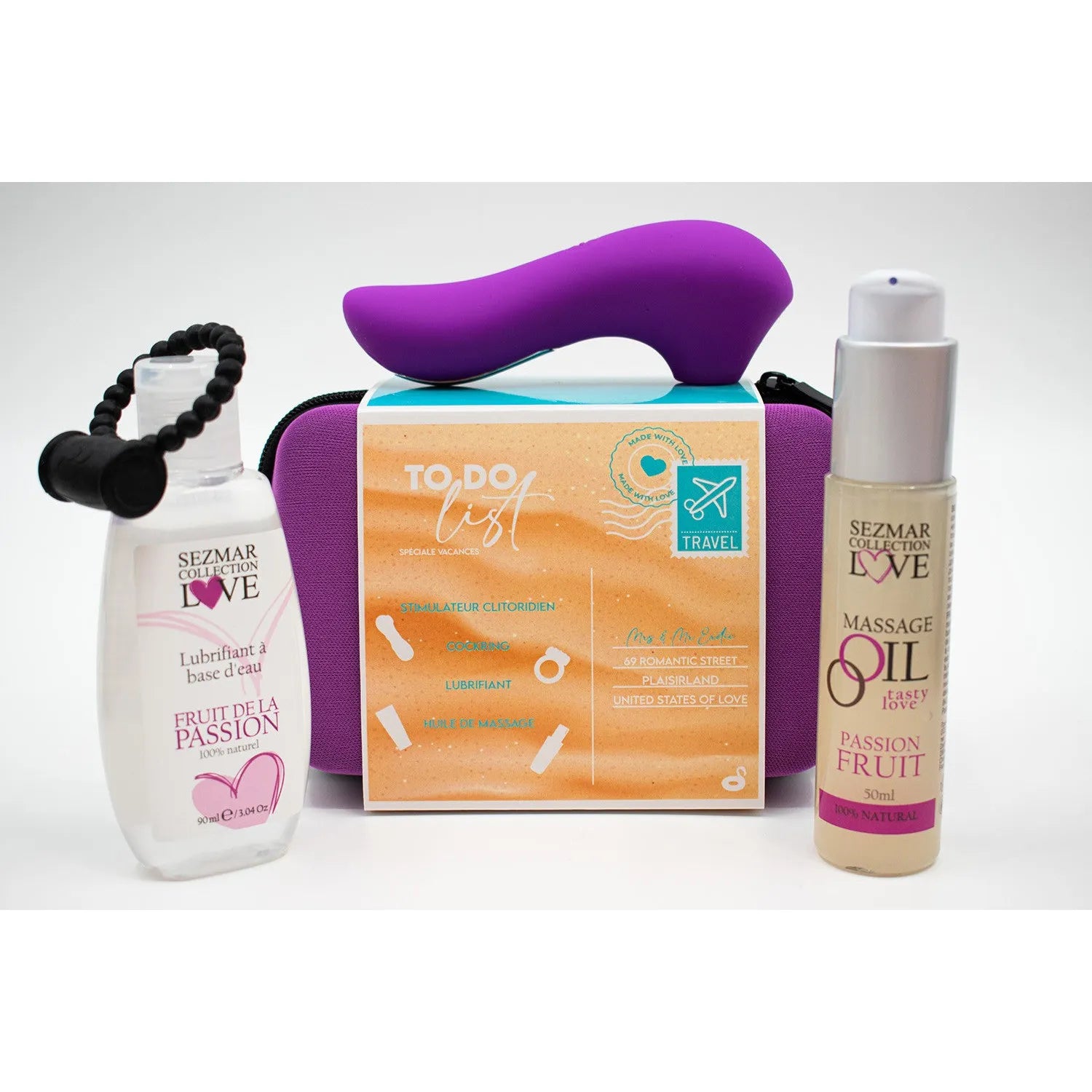 Box couple été avec stimulateur violet, huile massage passion, lubrifiant fruité, sur fond blanc.