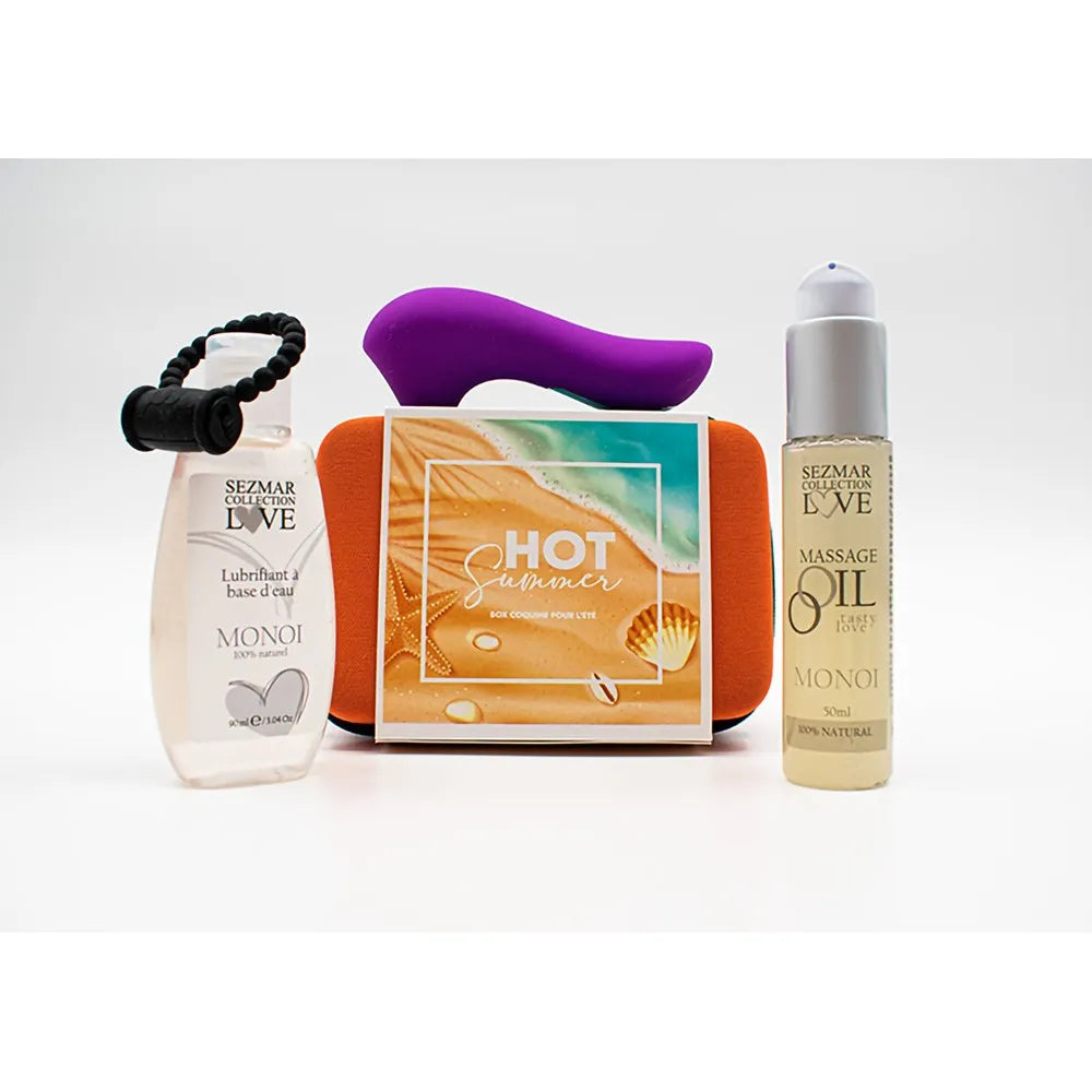 Box Couple Été Monoï avec stimulateur violet, anneau vibrant noir, huile massage et lubrifiant sur fond blanc.