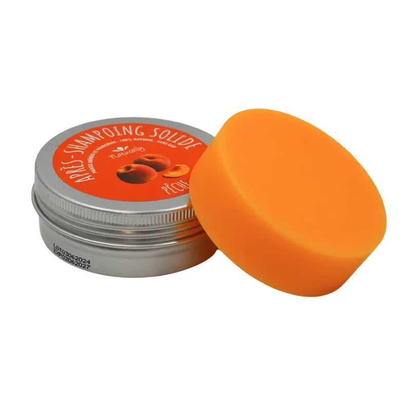 Après-shampoing solide orange en boîte métallique, étiquette pêche et mangue, 50g, soin cheveux naturels.