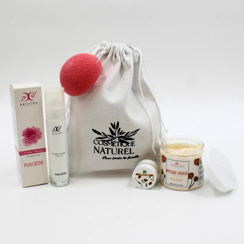 Coffret soin visage peau sèche avec beurre de karité, crème hydratante, masque et éponge rose, sur fond blanc.