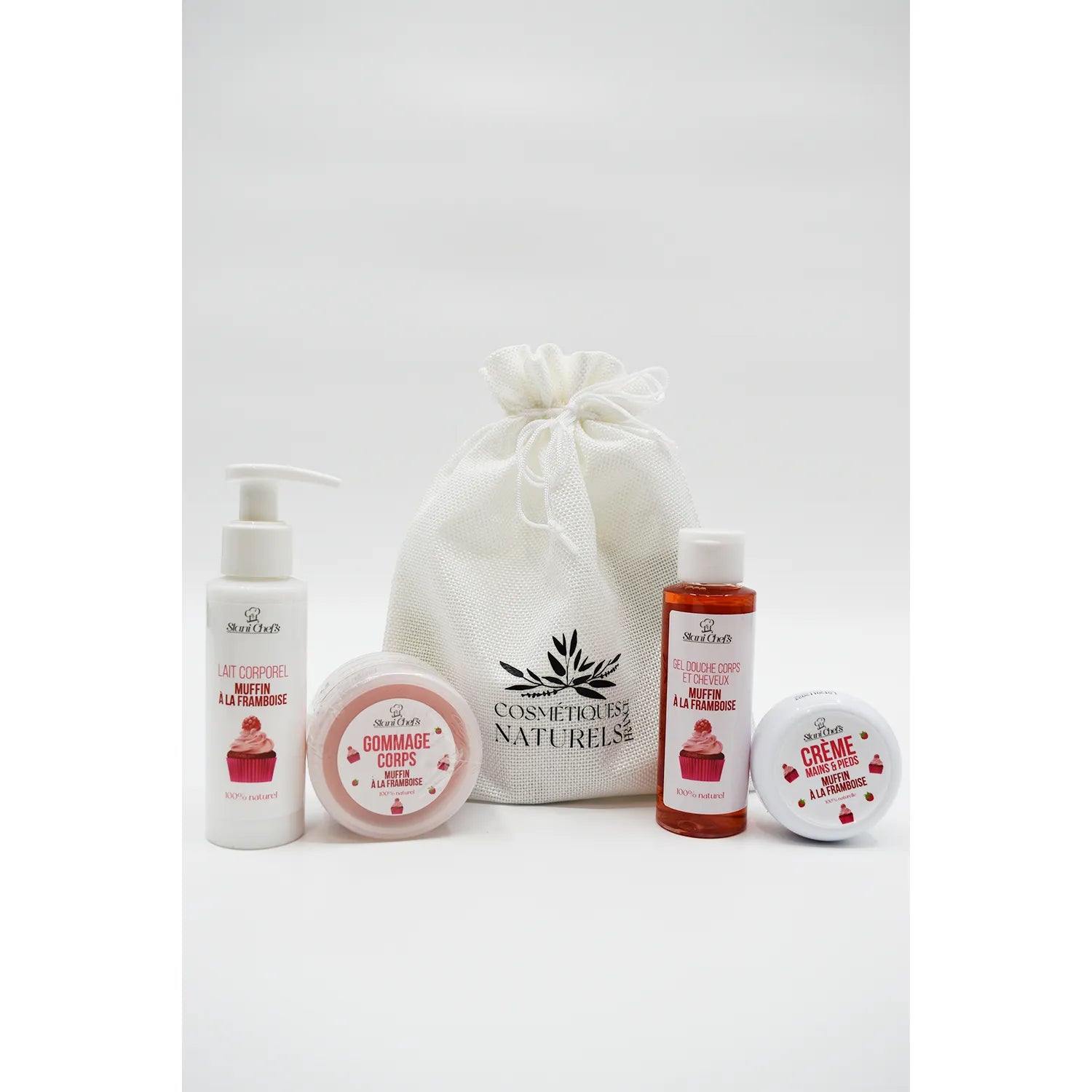 Coffret découverte muffin à la framboise avec lait corporel, gommage, gel douche et crème, emballage blanc élégant.