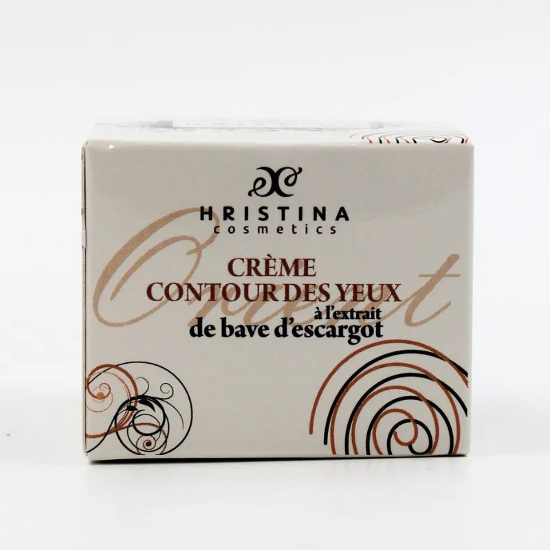 Crème contour yeux anti-âge bave escargot, boîte blanche élégante avec motifs dorés, pour peau mature et sensible.