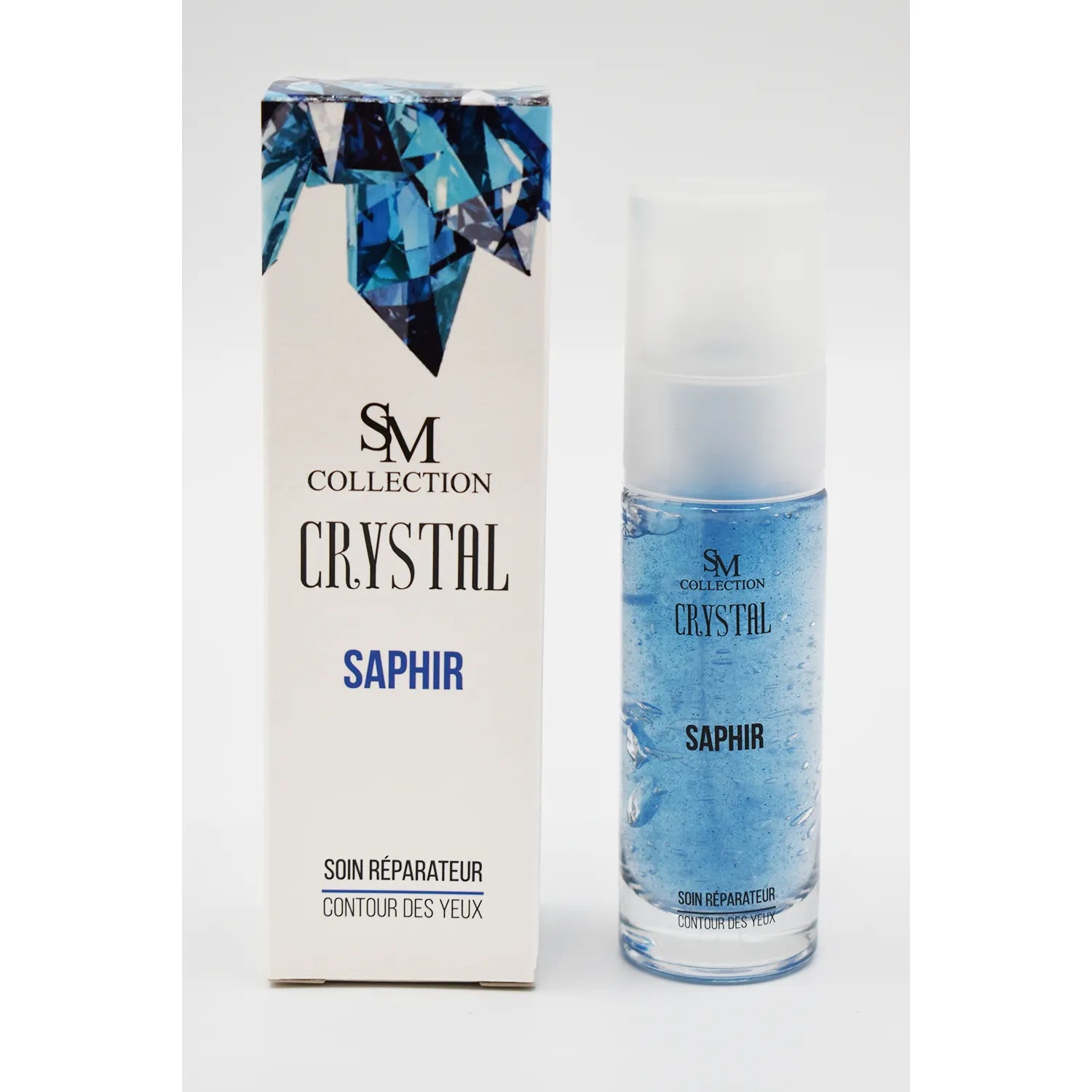 Flacon de crème contour yeux bleu avec poudre de saphir, boîte blanche décorée de cristaux bleus, pour peau mature.