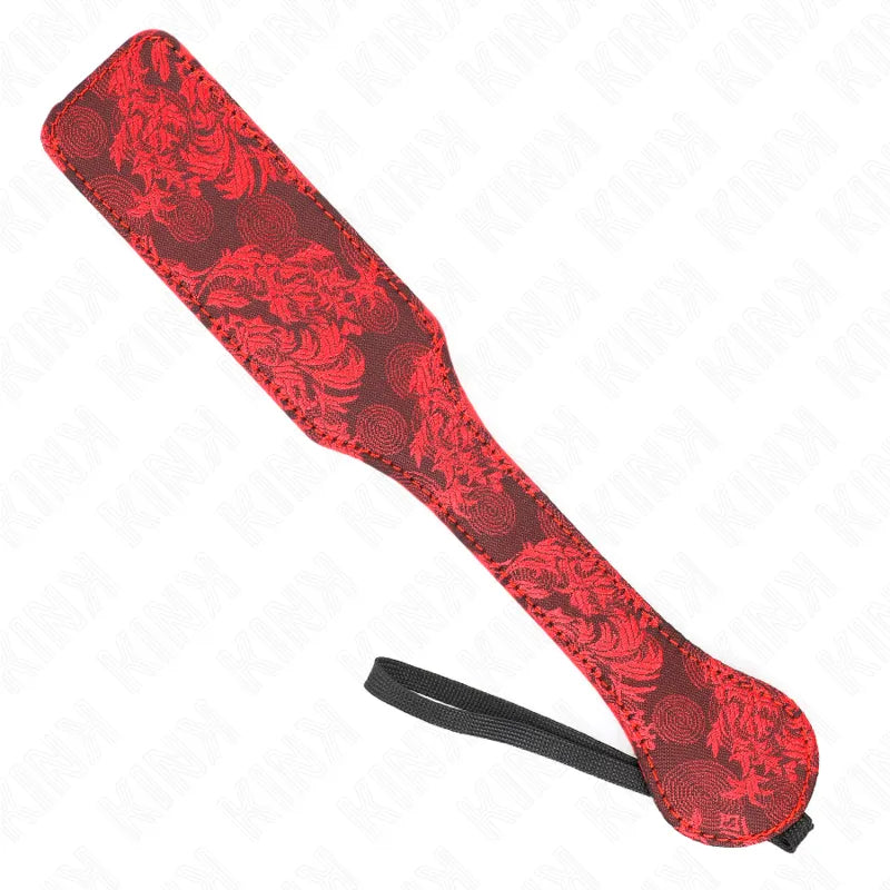 Pagaie BDSM en cuir rouge et noir avec motifs floraux, accessoire exclusif pour expériences intimes raffinées.