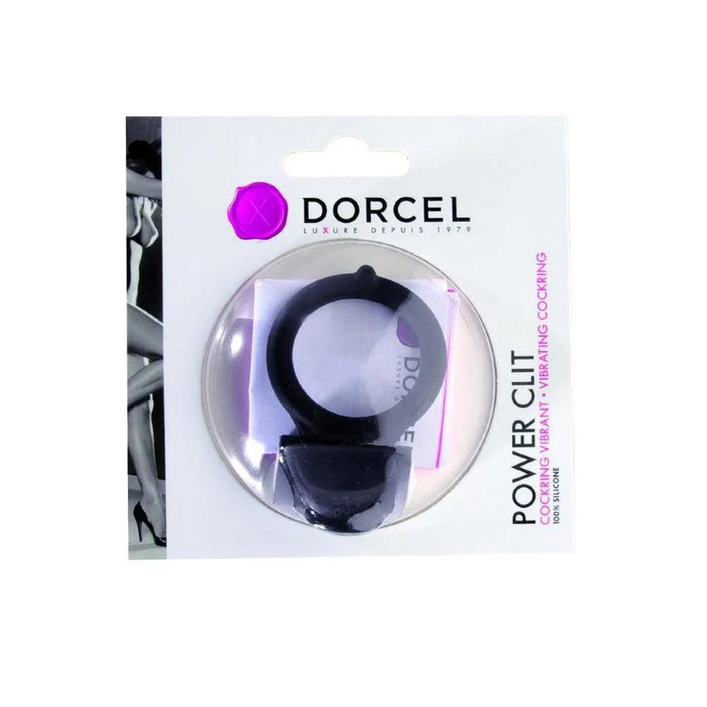 Anneau pénis noir vibrant en silicone avec languette clitoridienne, emballé dans une boîte transparente, piles incluses.