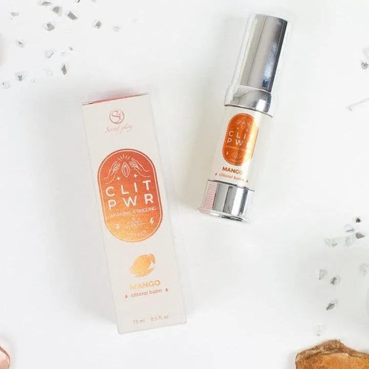 Baume clitoridien stimulant mangue, flacon argenté et boîte orange, intensifie sensations et orgasmes puissants.