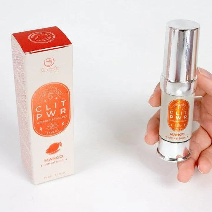 Baume clitoridien stimulant mangue, flacon argenté et boîte orange, intensifie sensations pour orgasmes puissants.