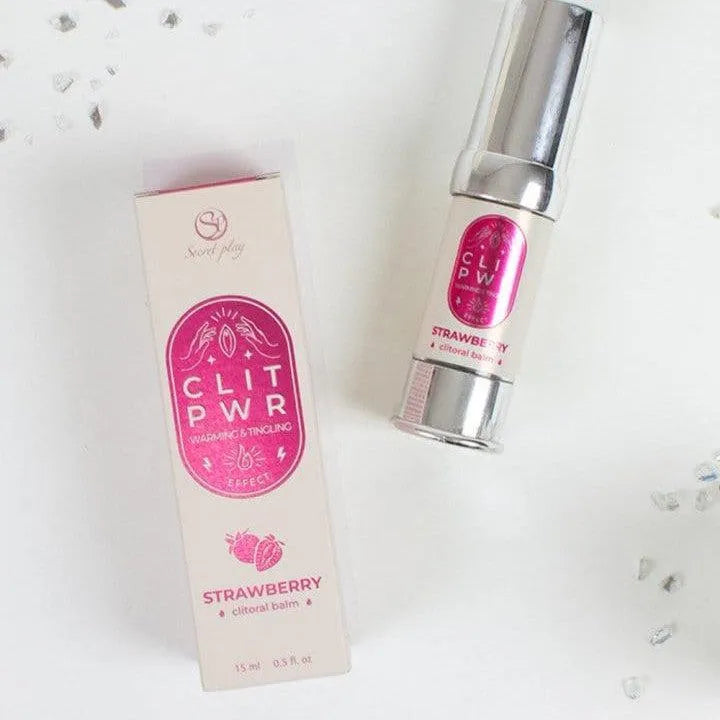 Baume stimulant clitoris fraise, flacon argenté et boîte rose, intensifie le plaisir féminin avec chaleur et vibration.