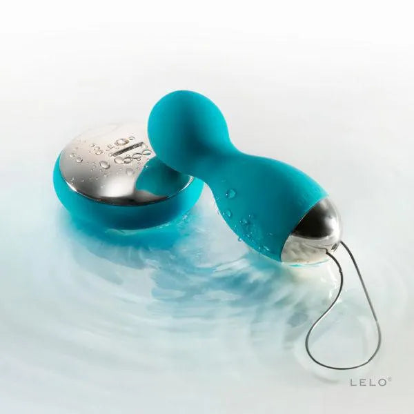 Boules de plaisir bleues rotatives avec télécommande argentée, design ergonomique et étanche pour stimulation sensorielle.