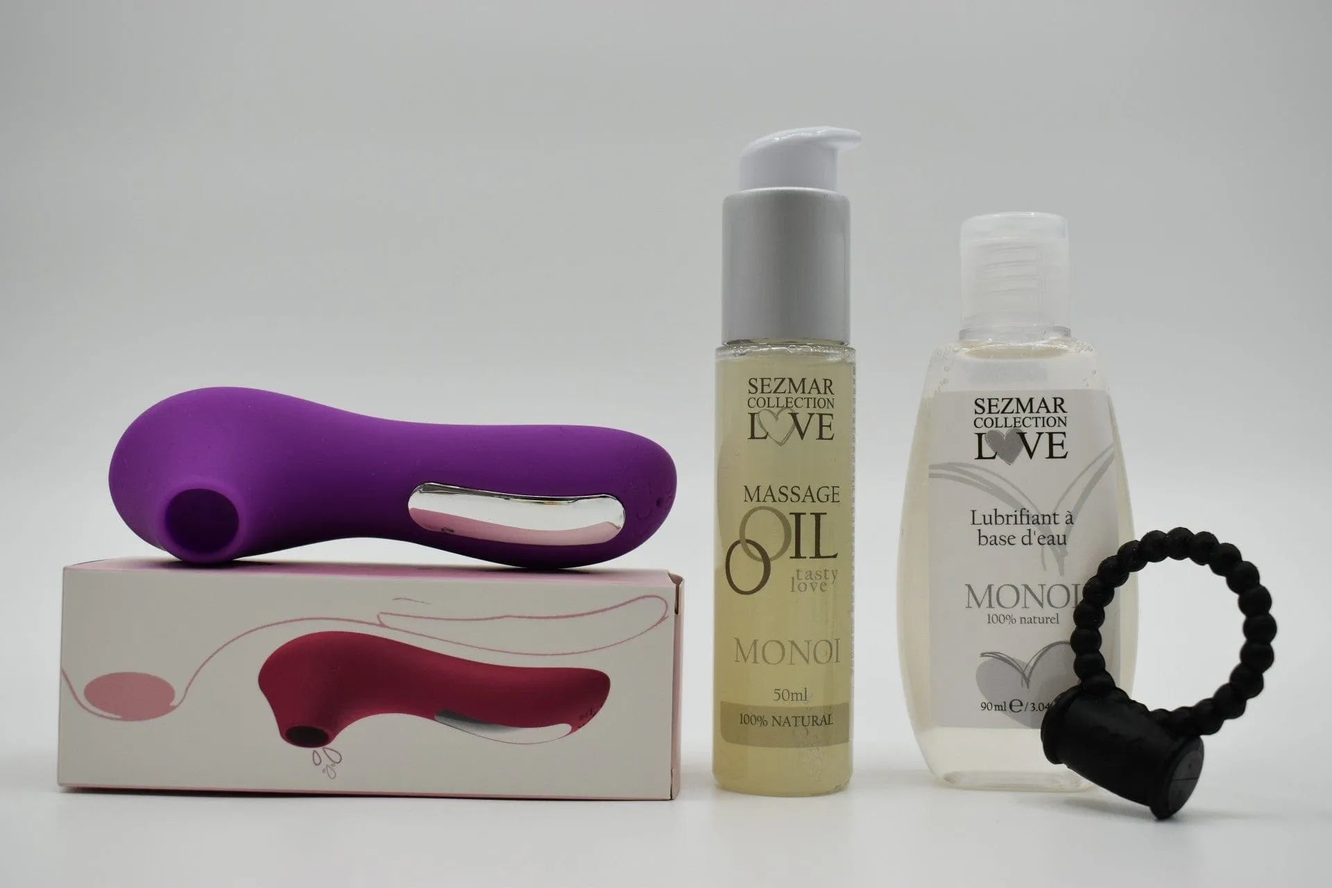 Box Couple Été avec huile de massage Monoï, lubrifiant Monoï, et accessoire violet, pour moments de détente estivale.