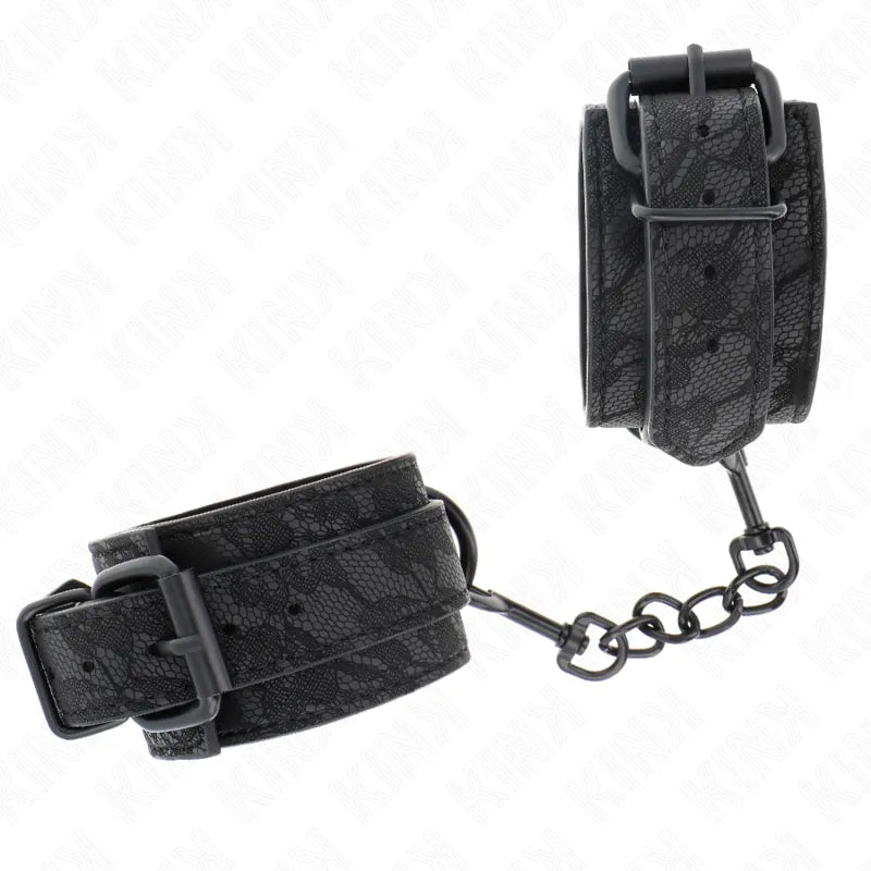 Bracelets BDSM en cuir noir véritable, robustes et confortables, avec boucles réglables et chaîne de liaison.