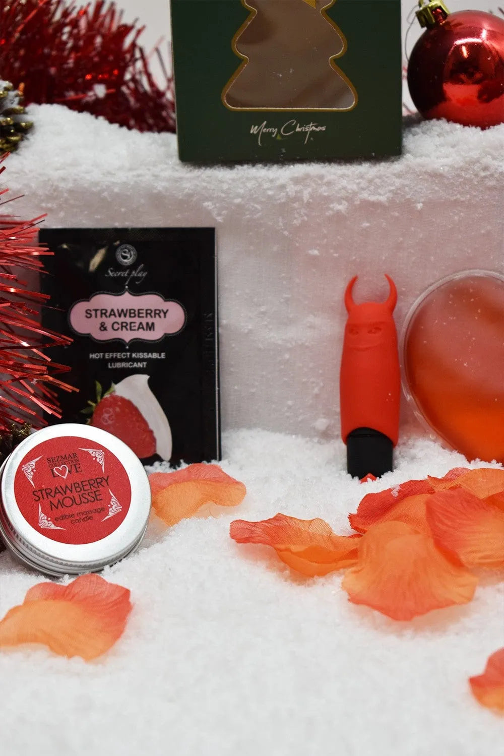 Coffret Massage Et Plaisir Noël, huile fraise, cœur chauffant, bougie, pétales de rose, ambiance festive.