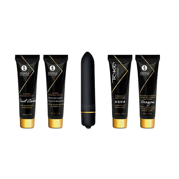 Coffret Shunga érotique: tubes noirs et dorés, stimulateur noir, pour couples explorant plaisir et intimité.