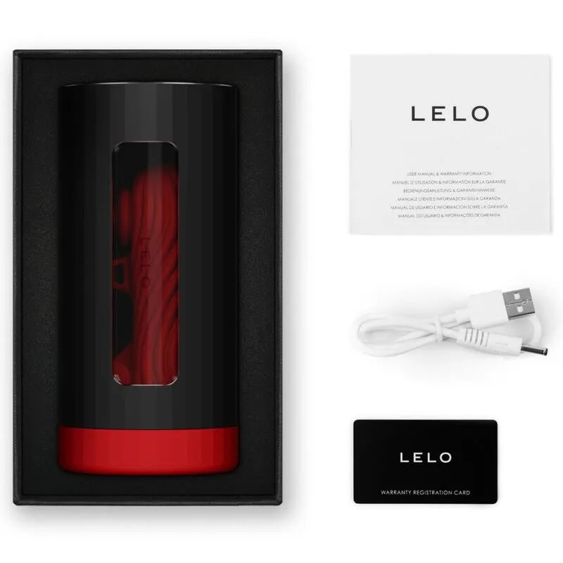 Console Plaisir Luxe Connectée en silicone rouge et noir, avec câble USB et manuel, dans un coffret élégant.