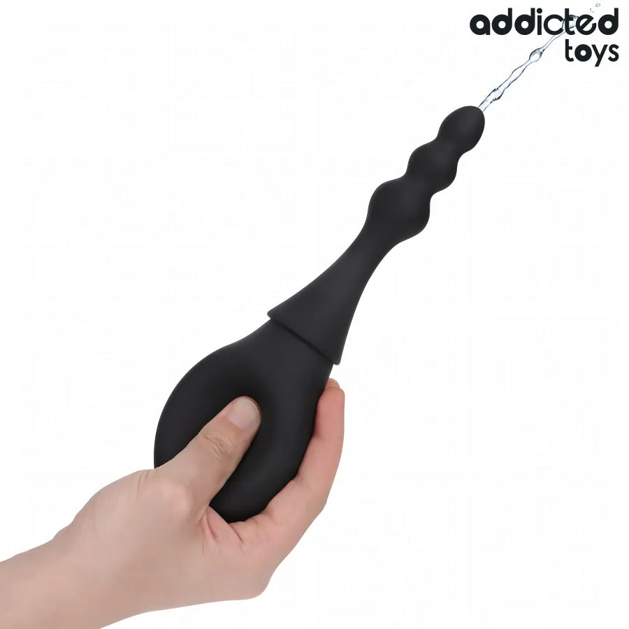Nettoyeur de voyage Addicted Toys noir, design compact, poignée ergonomique, idéal pour désinfection rapide des jouets.