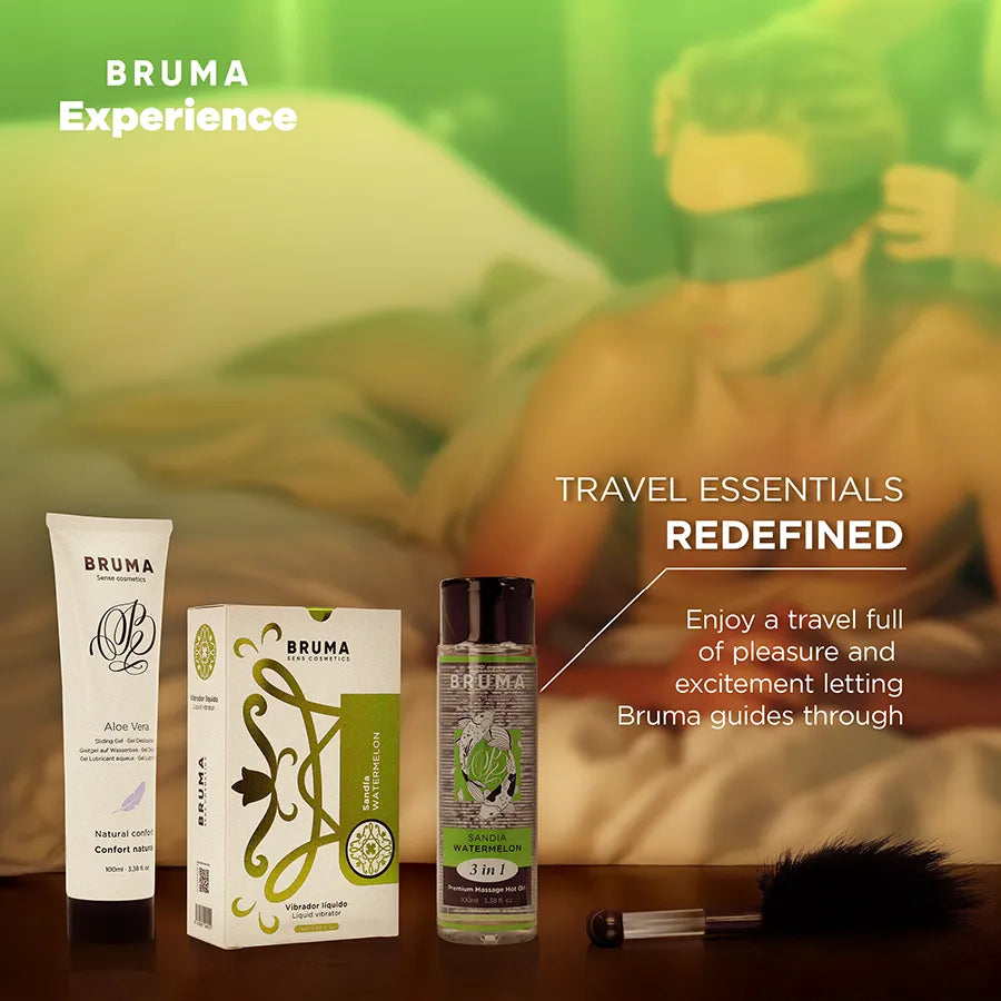 Kit Bruma Xperience avec lubrifiant pastèque, huile, plume noire et bandeau vert, sur fond tropical sensuel.