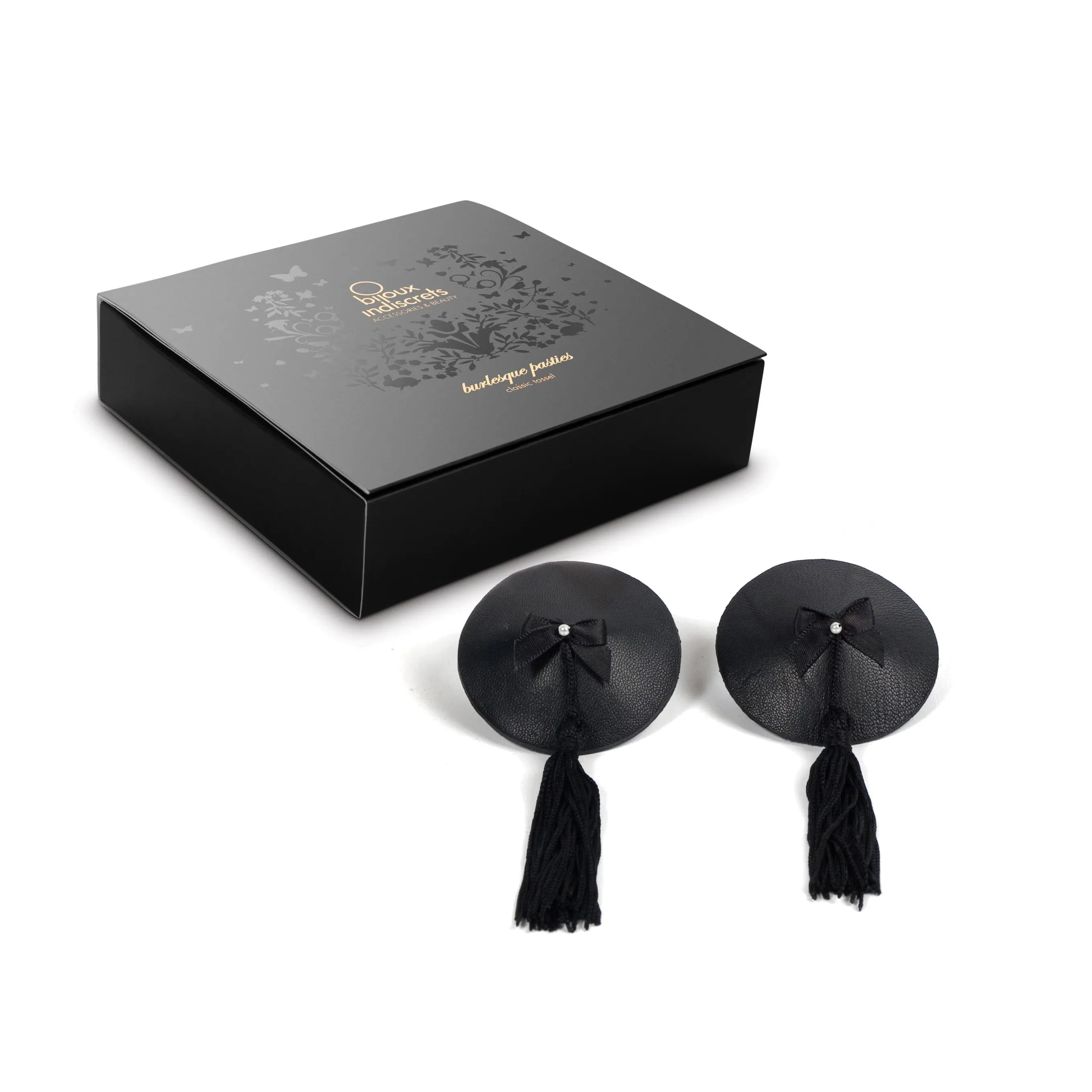 Cache-tétons burlesque noirs avec pompons et strass, élégants et réutilisables, présentés devant une boîte cadeau.