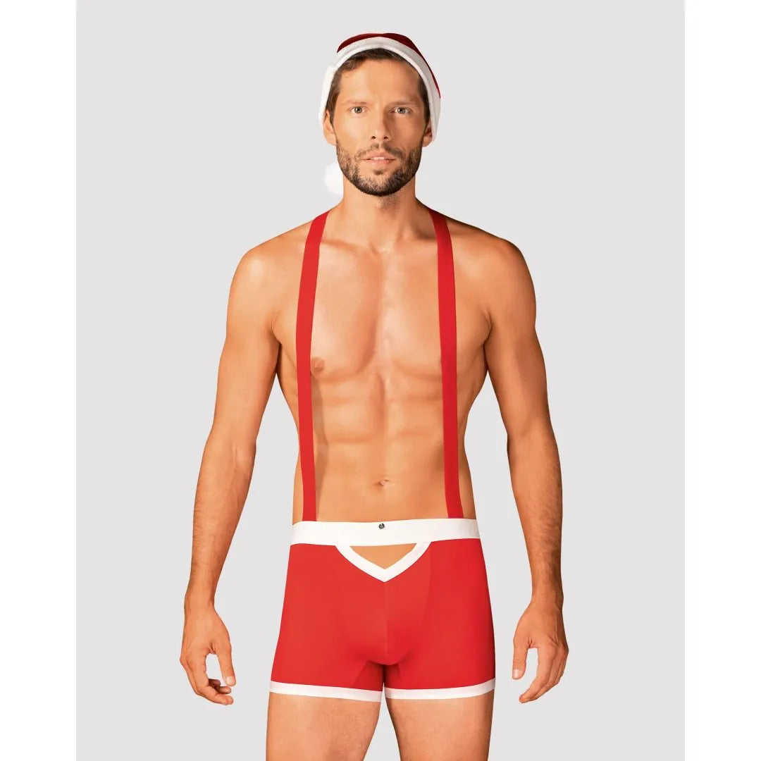 Caleçon rouge homme style Père Noël avec bretelles réglables et bonnet pompon, idéal pour fêtes de fin d'année.