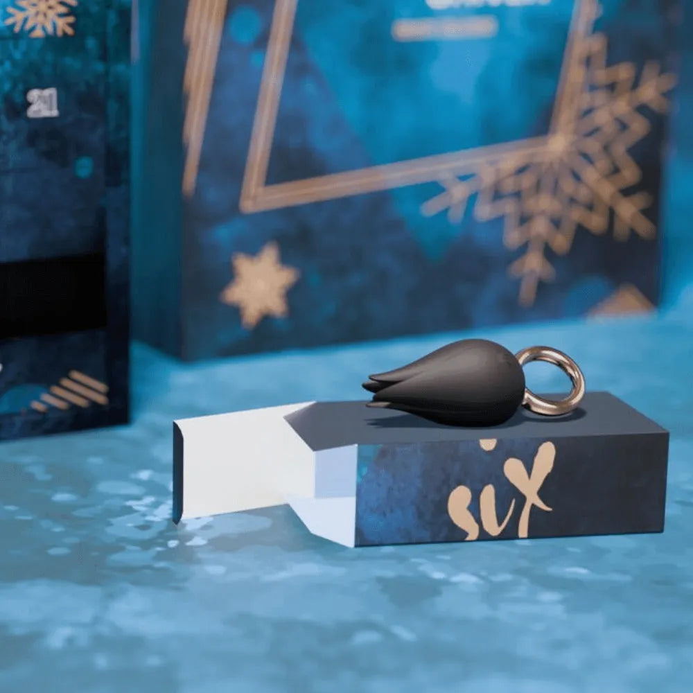 Calendrier de l'Avent érotique bleu avec boîte cadeau et jouet intime noir, motif flocons dorés.