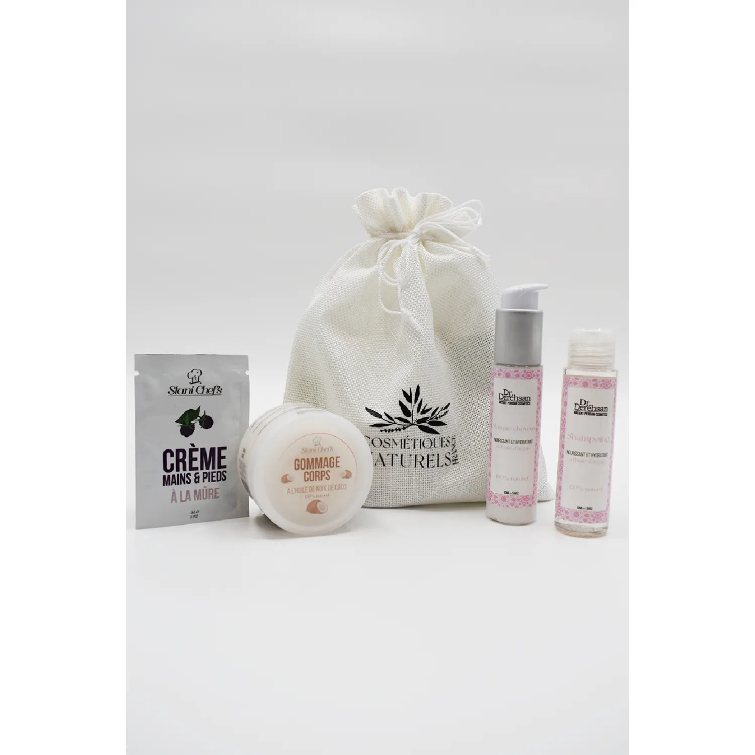 Coffret découverte corps cheveux avec shampoing à l'huile d'argan, crème, gommage, et sac en toile blanche.