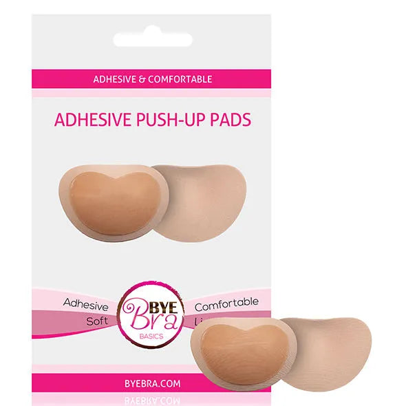 Coussinets push-up adhésifs beige en forme de cœur, doux et légers, pour soutien-gorge, sur emballage blanc et rose.